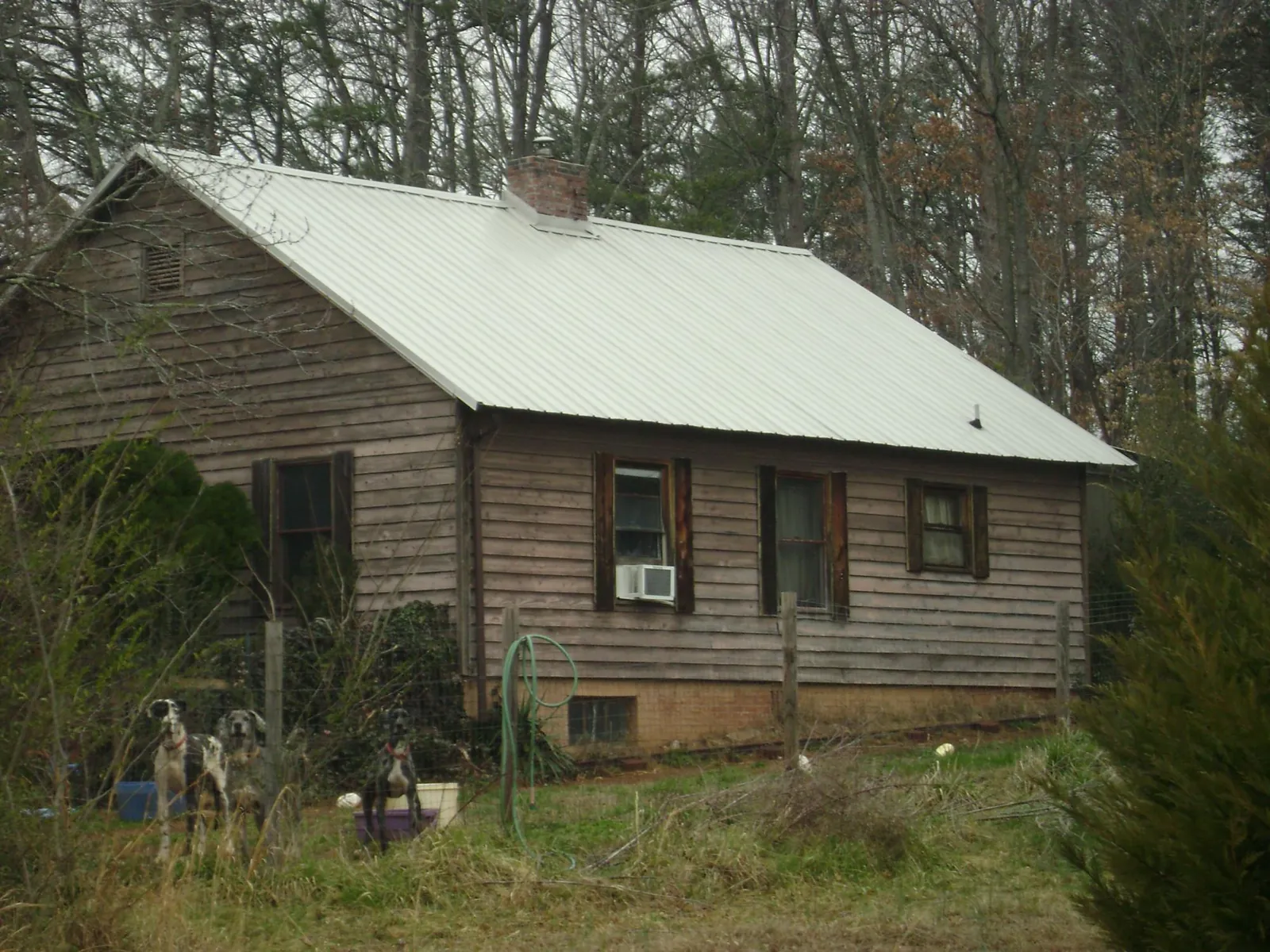 White metal roof on an old wood sided farmhouse, from a Metal Roof Installation job in Saint Meinrad